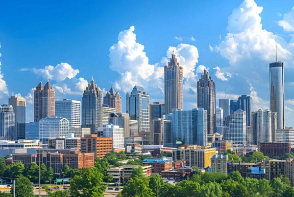 Homepage - Downtown Atlanta Skyline Showing Several Prominent Buildings and Hotels Under a Blue Sky